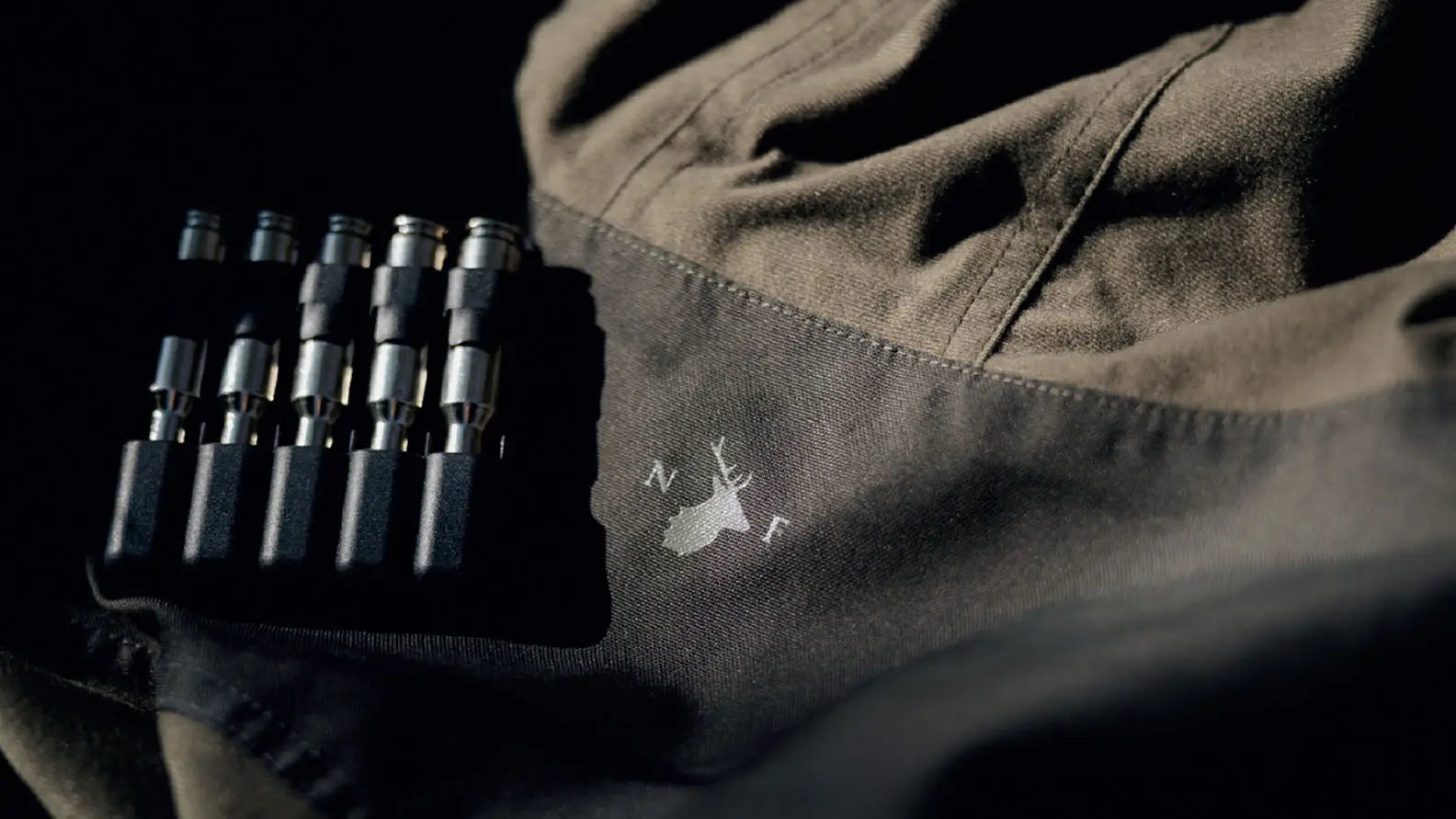 Dark forest clothing fabric with cartridge holder for stalking sessions in Keith Edmunds style