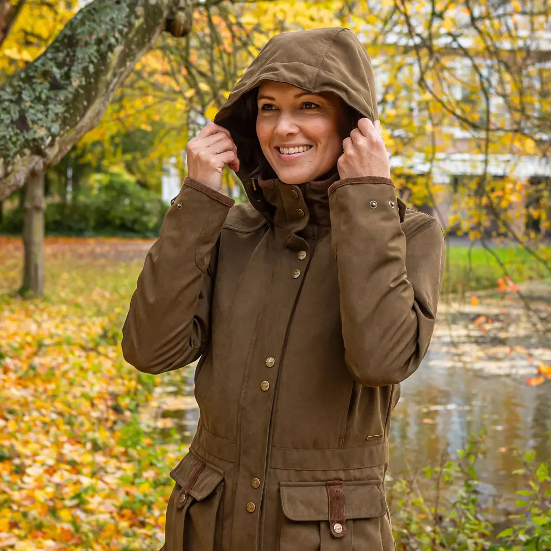 Woman wearing a Baleno Ladywood Jacket in a stylish hooded brown coat
