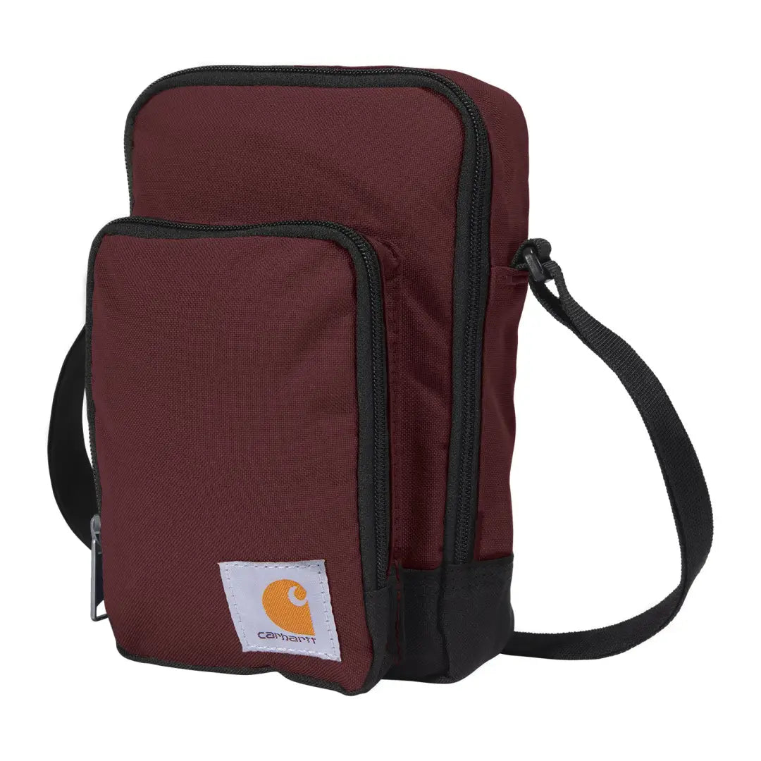 Maroon Carhartt crossbody zip bag with black zipper trim and strap