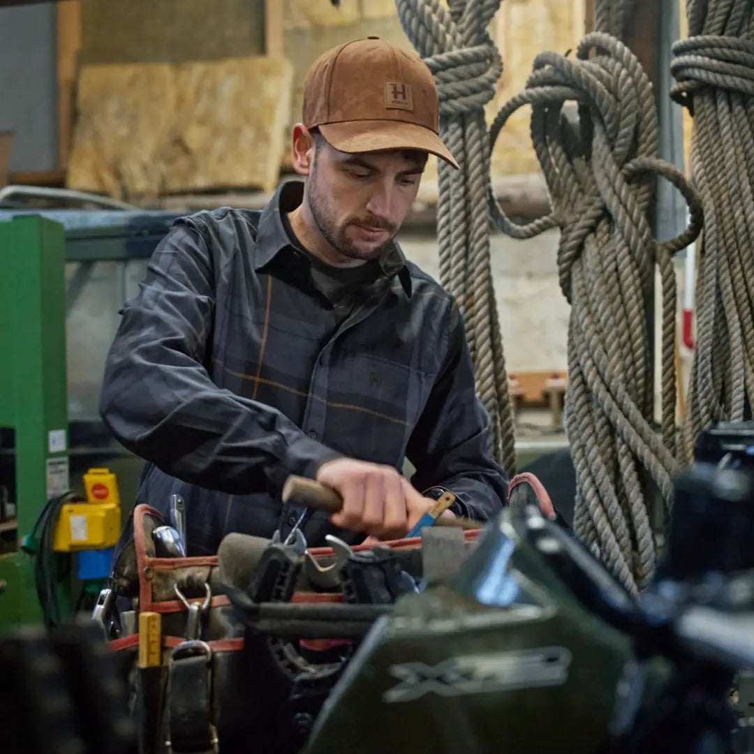 Man wearing Berkshire Cap with tool belt, perfect for country clothing and hunting gear