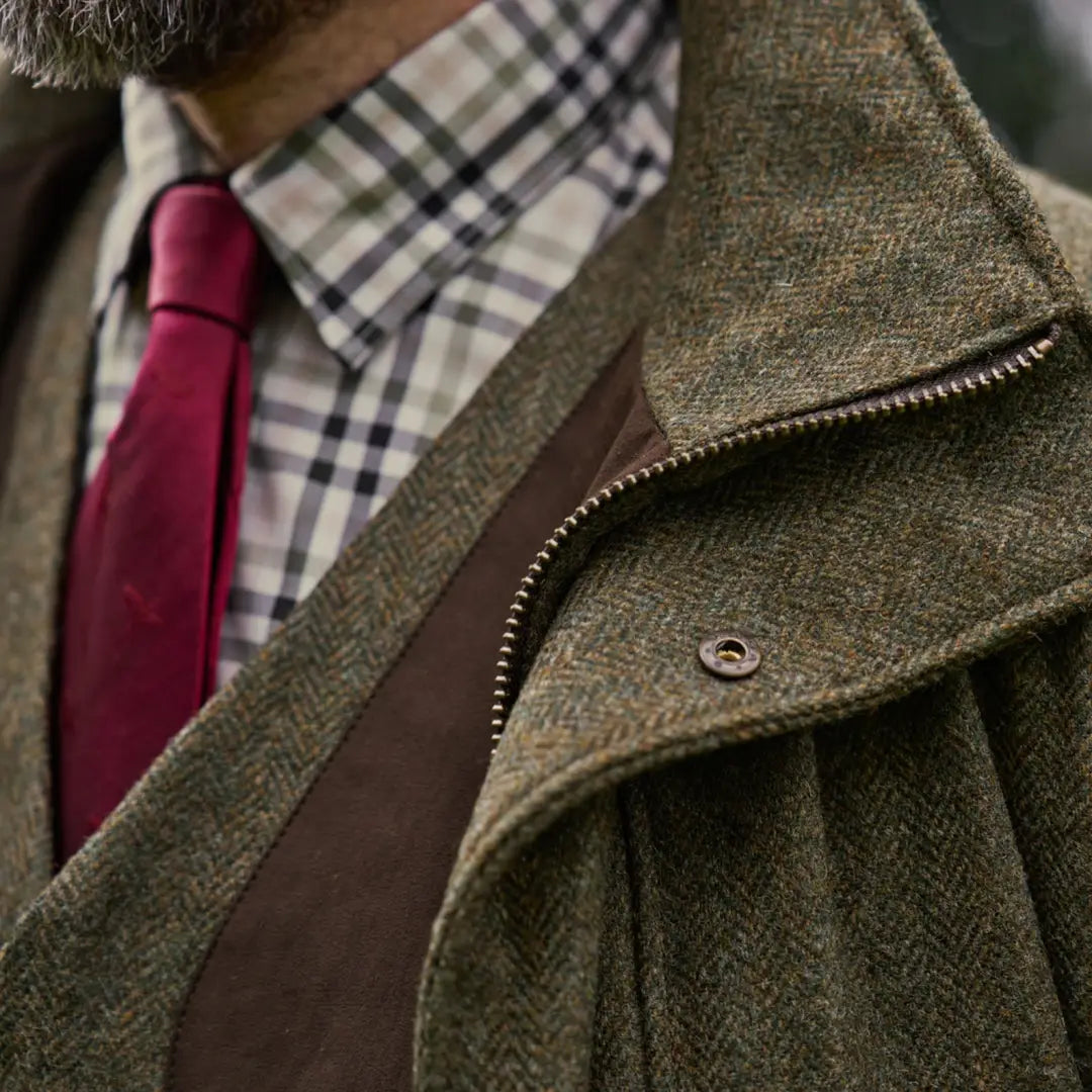 Herringbone tweed jacket with red tie showcasing the Harkila Kenmore GTX Jacket for outdoor style