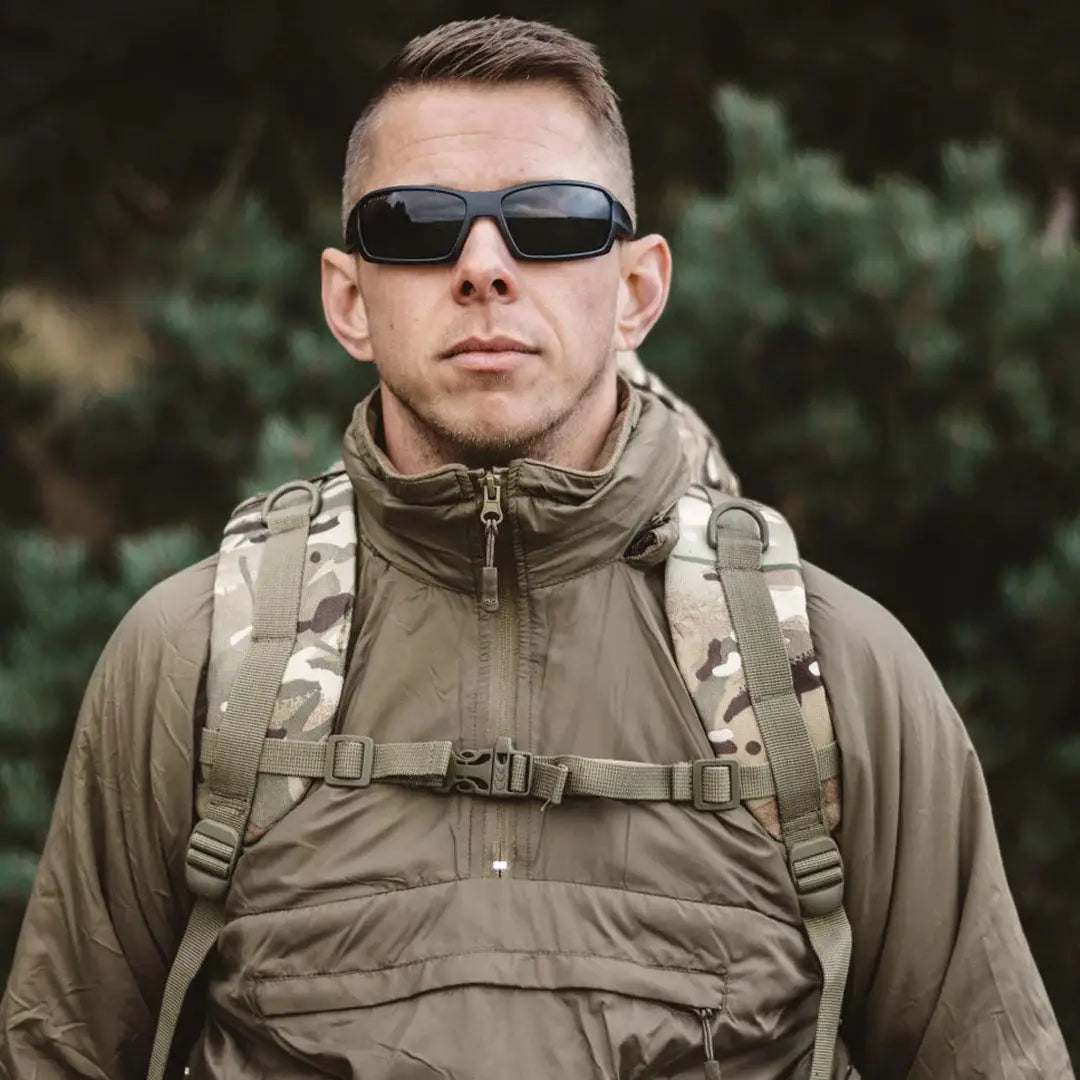 Man in tactical gear showcasing the Highlander Halo Smock for outdoor adventures