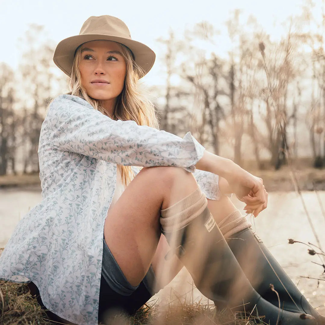 Woman in hat and rain boots showcasing the stylish Hoggs of Fife thistle print shirt