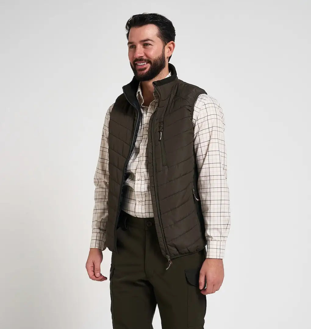 Dark olive Jack Pyke Hybrid Quilted Gilet vest over plaid shirt