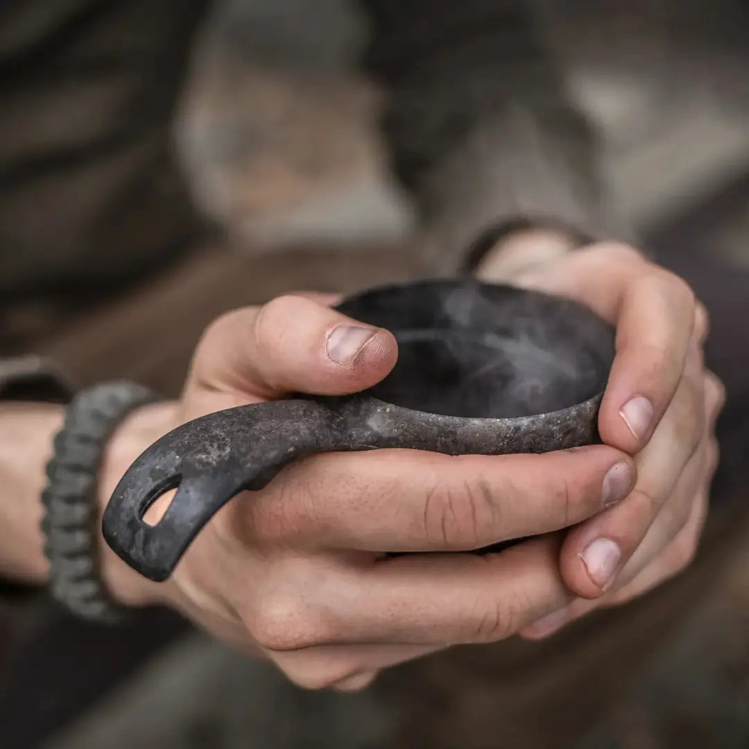Hand-held dark metal Kupilka Classic Cup perfect for country clothing, hunting, and outdoors