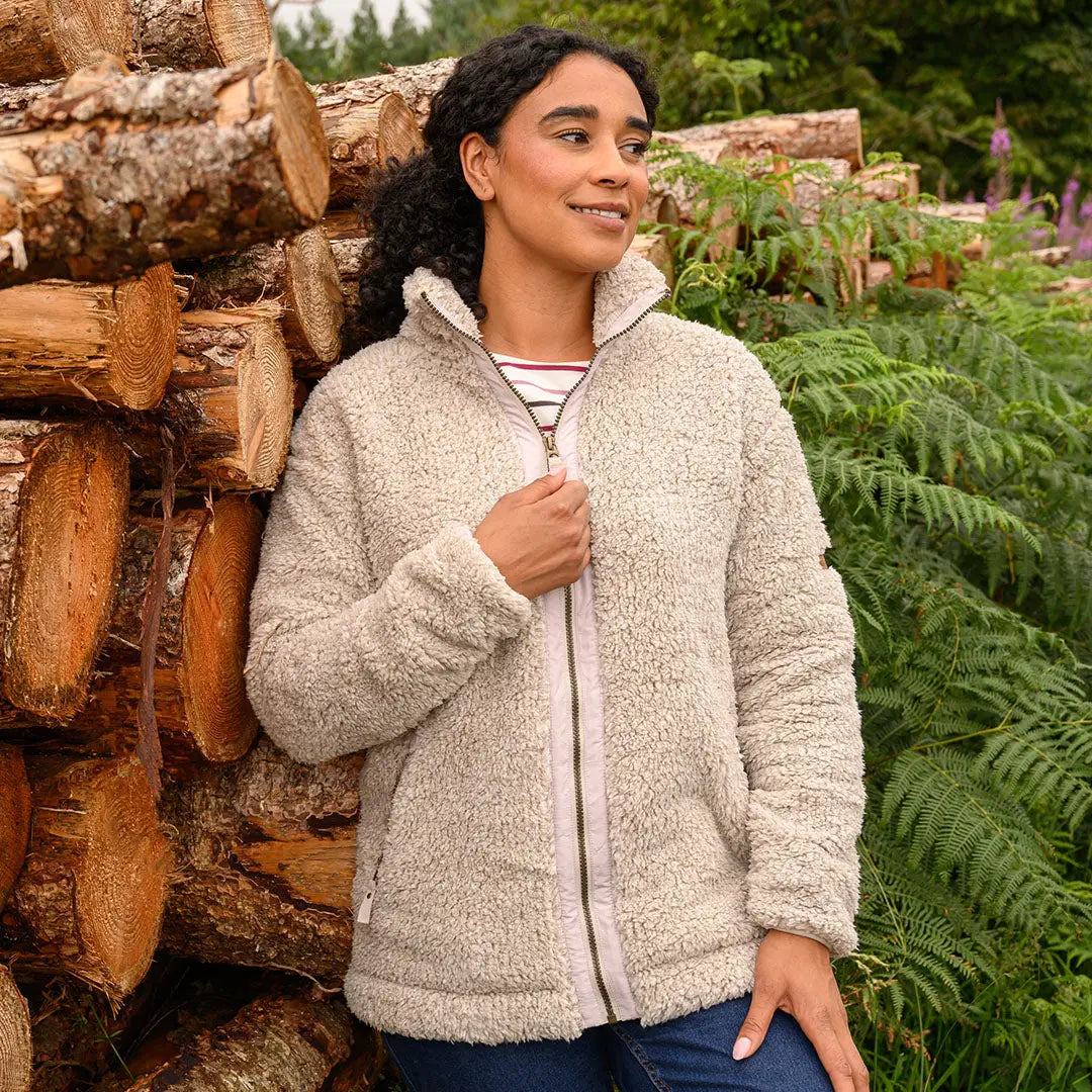 Woman in Lighthouse Cobh zip fleece country clothing in a cream-colored fleece jacket