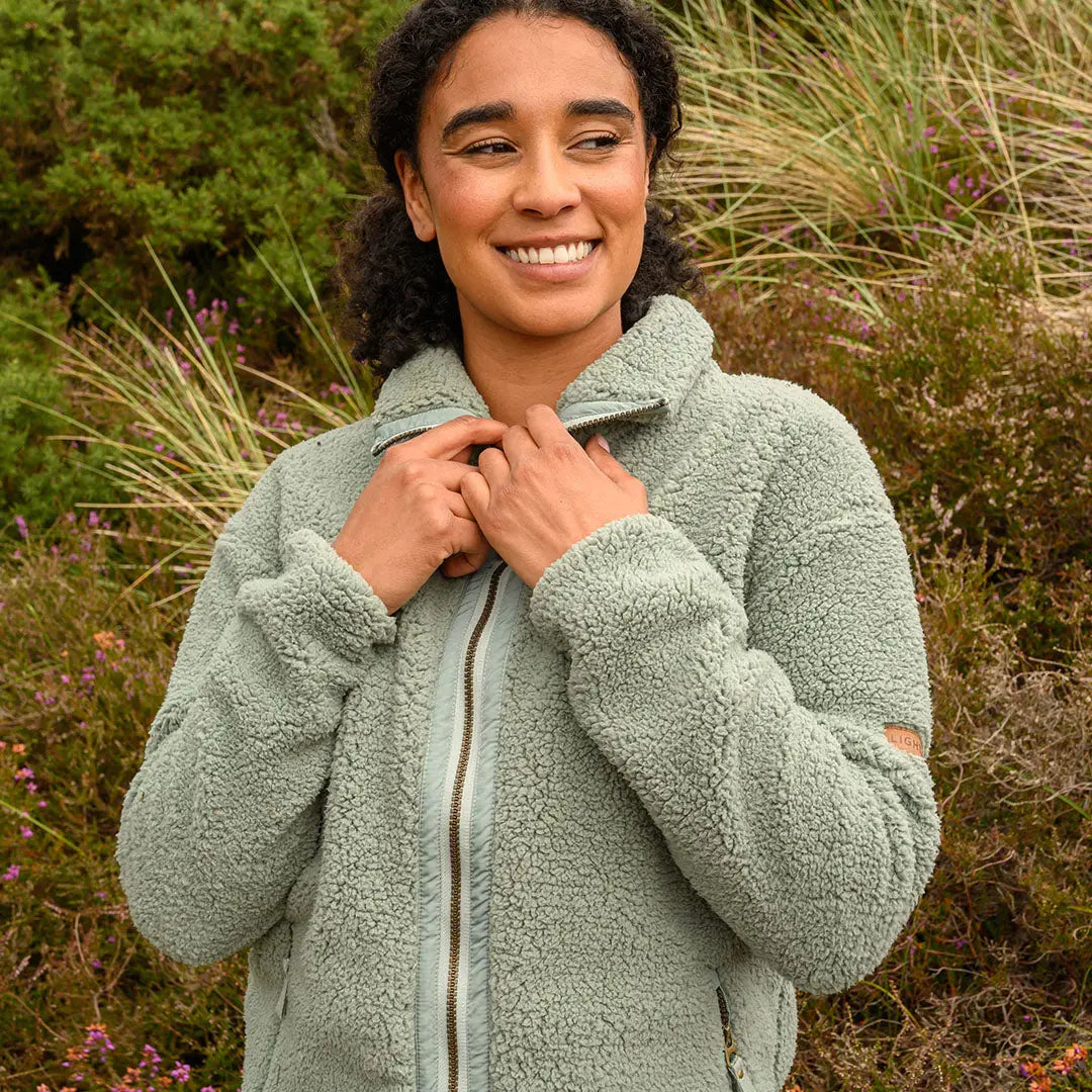Woman in a cozy light green Lighthouse Cobh zip fleece for country clothing style