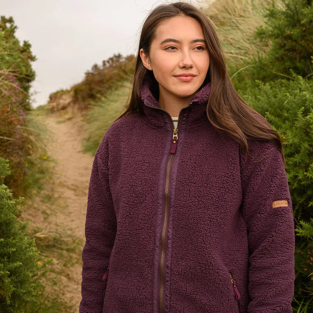 Woman in dark purple Lighthouse Cobh zip fleece for comfy country clothing look