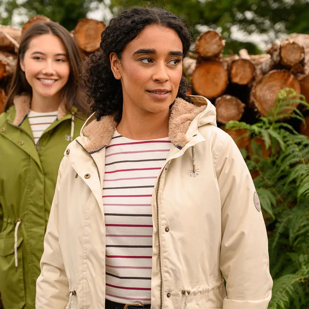 Two women wearing stylish lighthouse isobel coat hooded parkas with faux fur lining