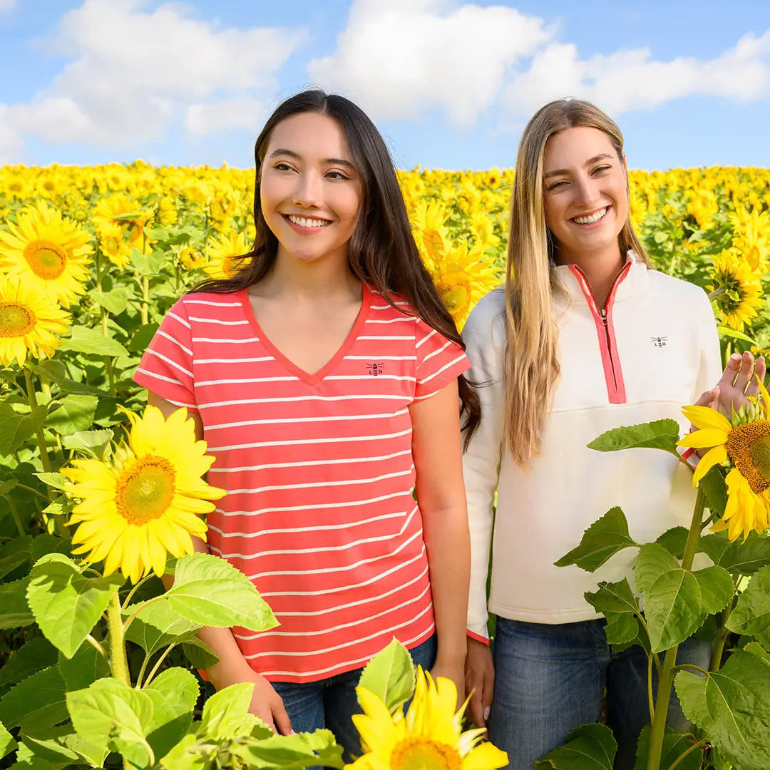 Two smiling women in sunflower field wearing Lighthouse Ladies Ariana Short Sleeve T-Shirt
