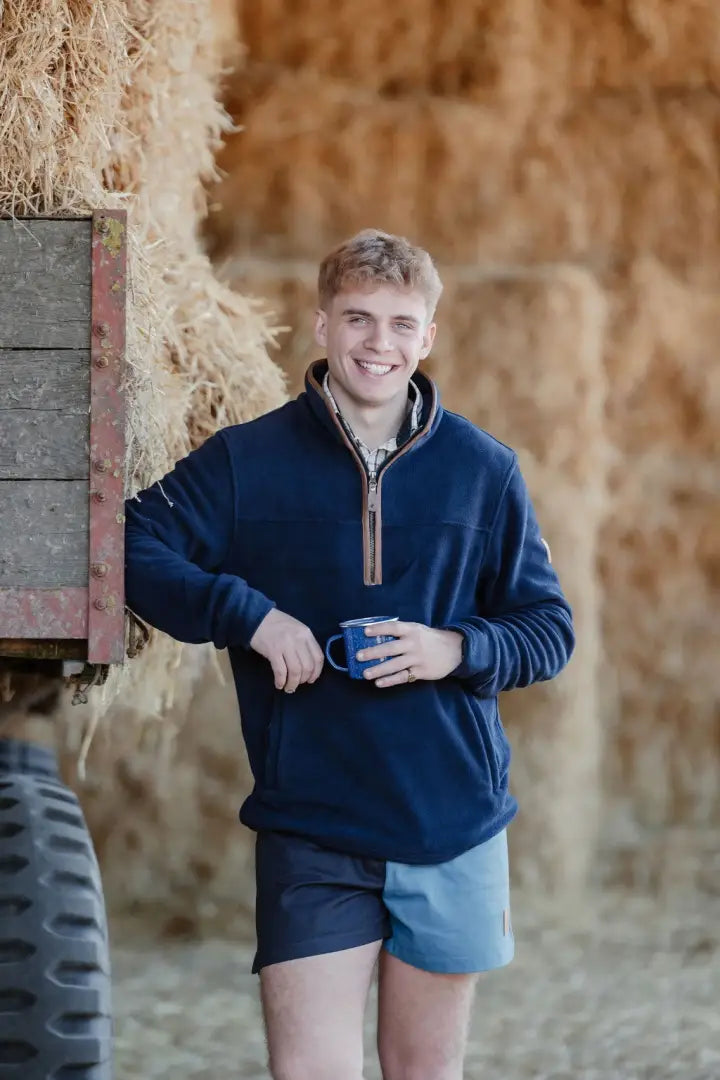 Smiling man in blue fleece and shorts wearing New Forest Harlequin Rugby Shorts for country clothing and hunting style