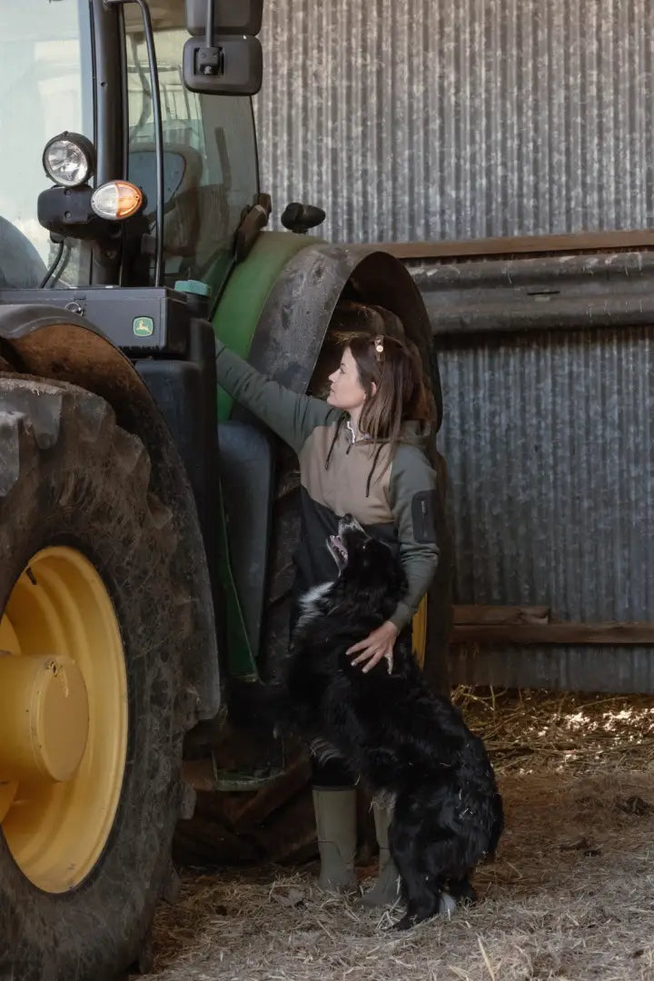Woman with dog by tractor in New Forest Ladies Raptor Hoodie showcasing forest raptor style