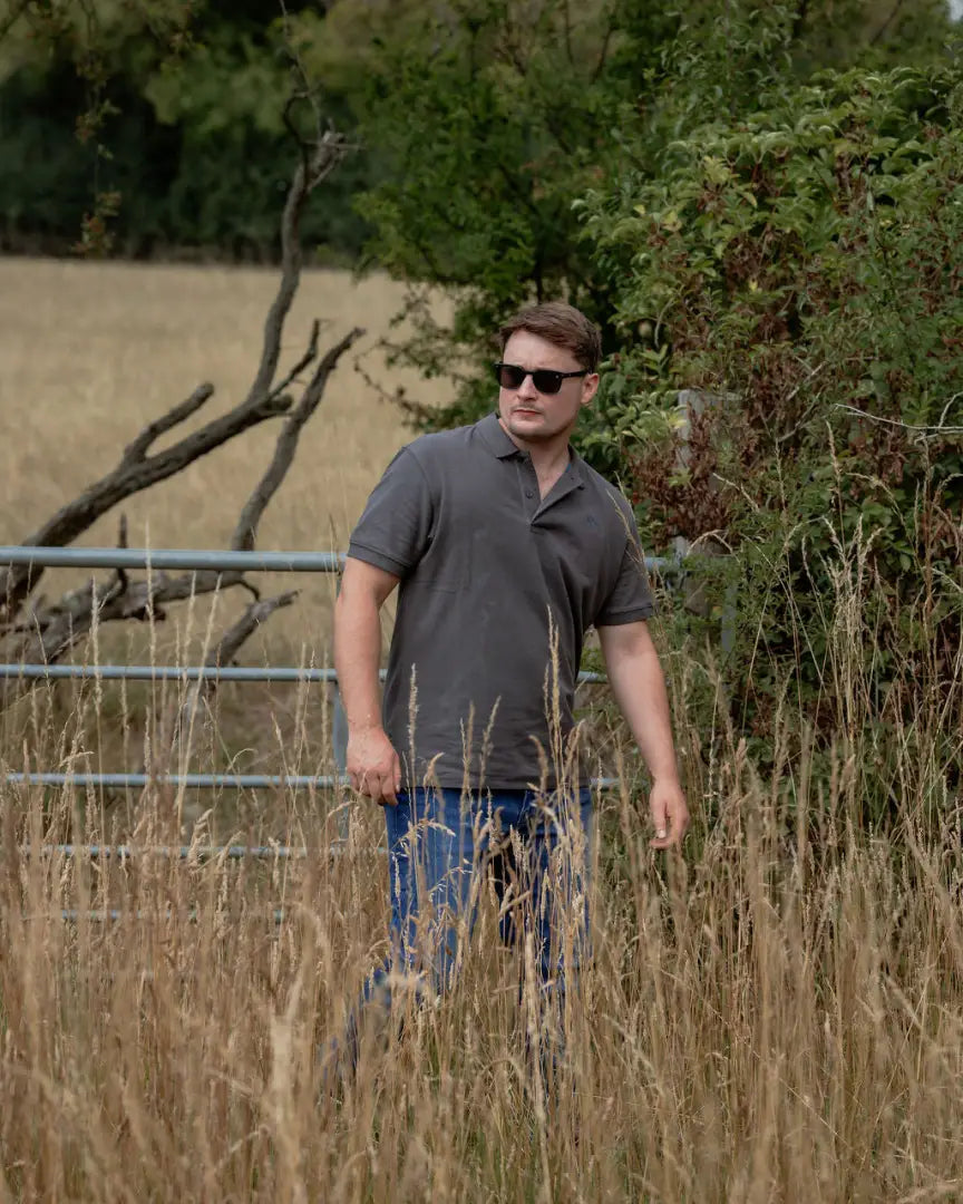 Man in sunglasses wearing the New Forest Pique Polo Shirt, perfect for casual style