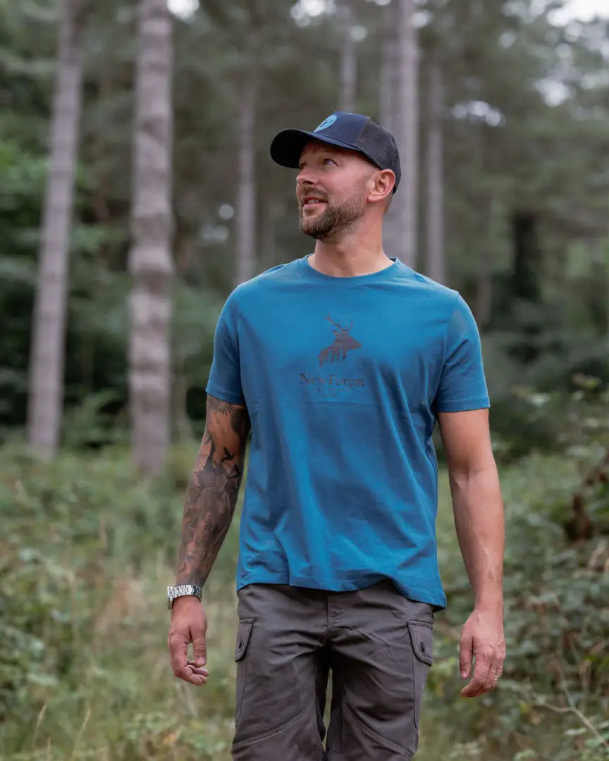 Man in blue T-shirt with New Forest Stag Logo forest stag graphic clothing t-shirt