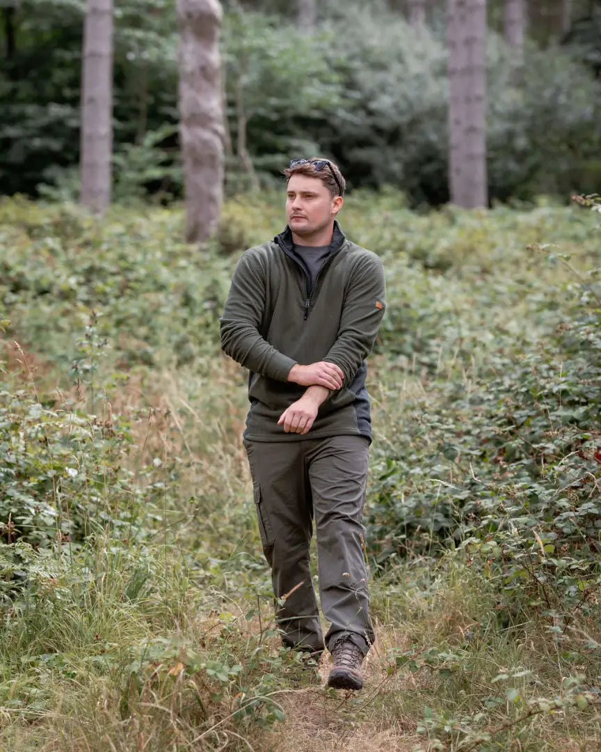 Man in outdoor clothing wearing New Forest Trail Fleece on forest trail