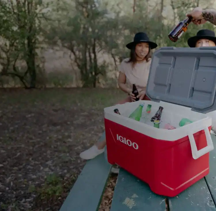 A red and white Igloo cooler filled with beverages.