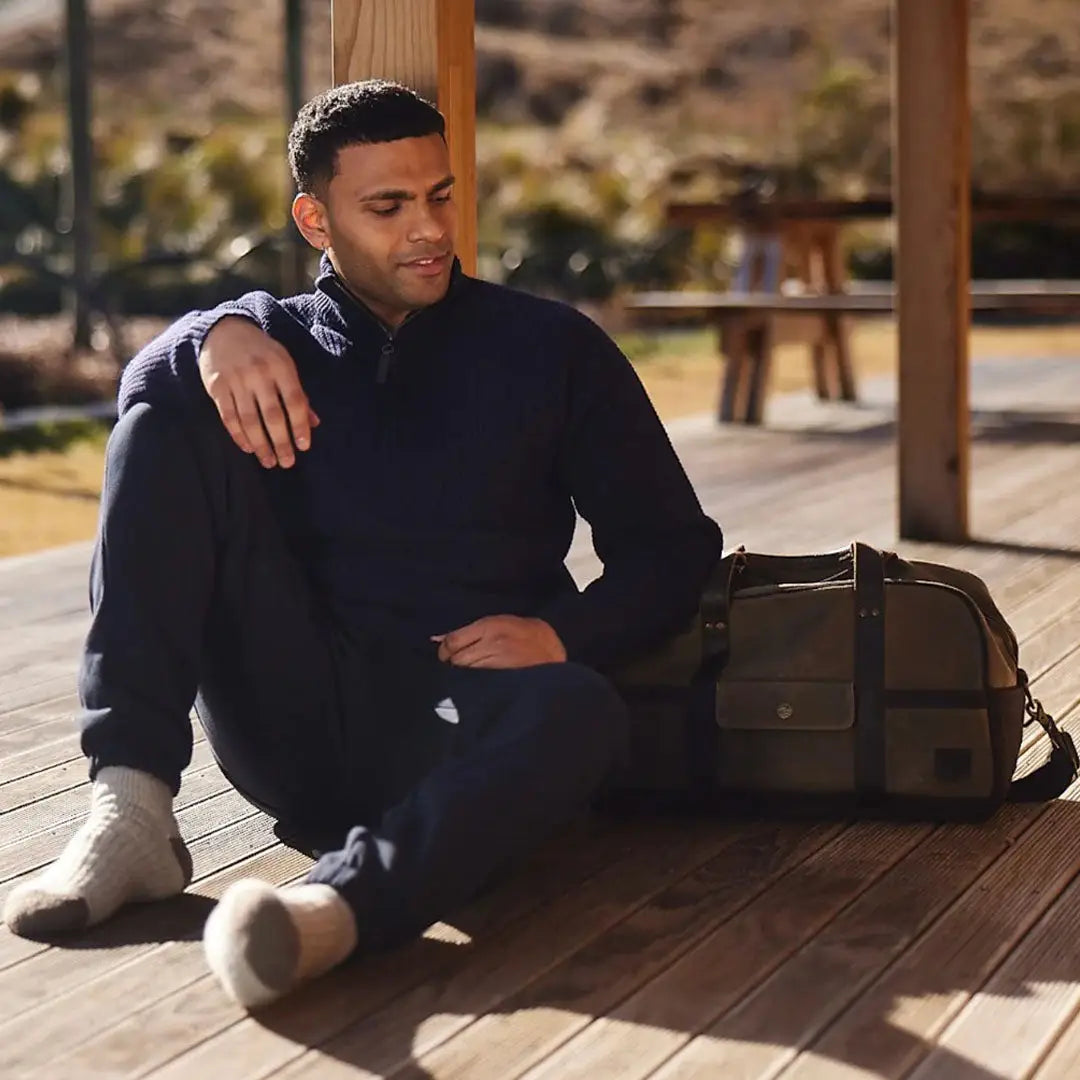 Man wearing swanndri kingston canvas dark blue quarter-zip sweater and sweatpants