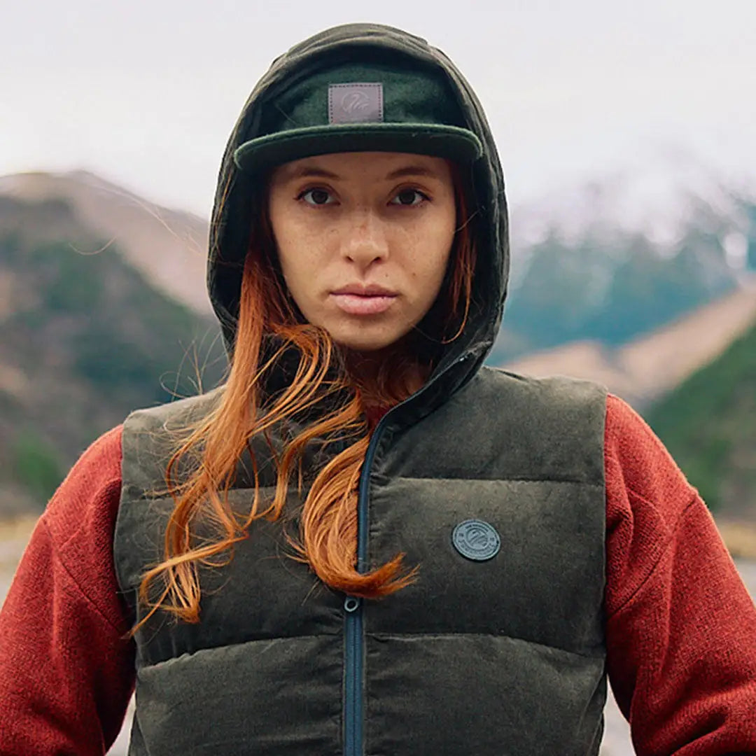 Woman in swanndri wentworth valley v2 wool cap and dark green puffer vest