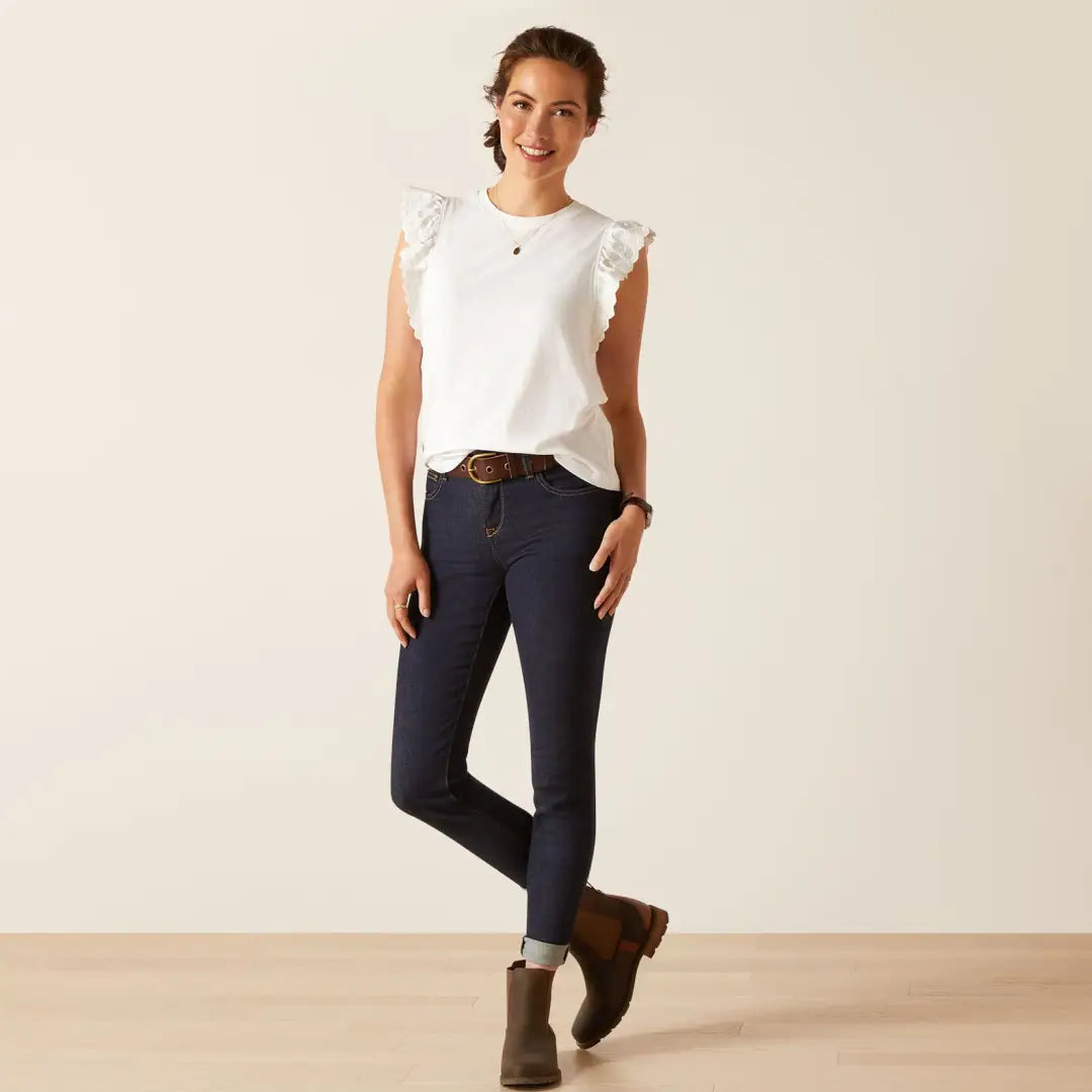 Woman in white sleeveless top, perfect for country clothing and outdoor adventures
