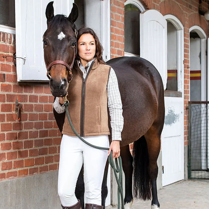 Dark brown horse with a person in Baleno Sally Ladies Fleece Bodywarmer outfit