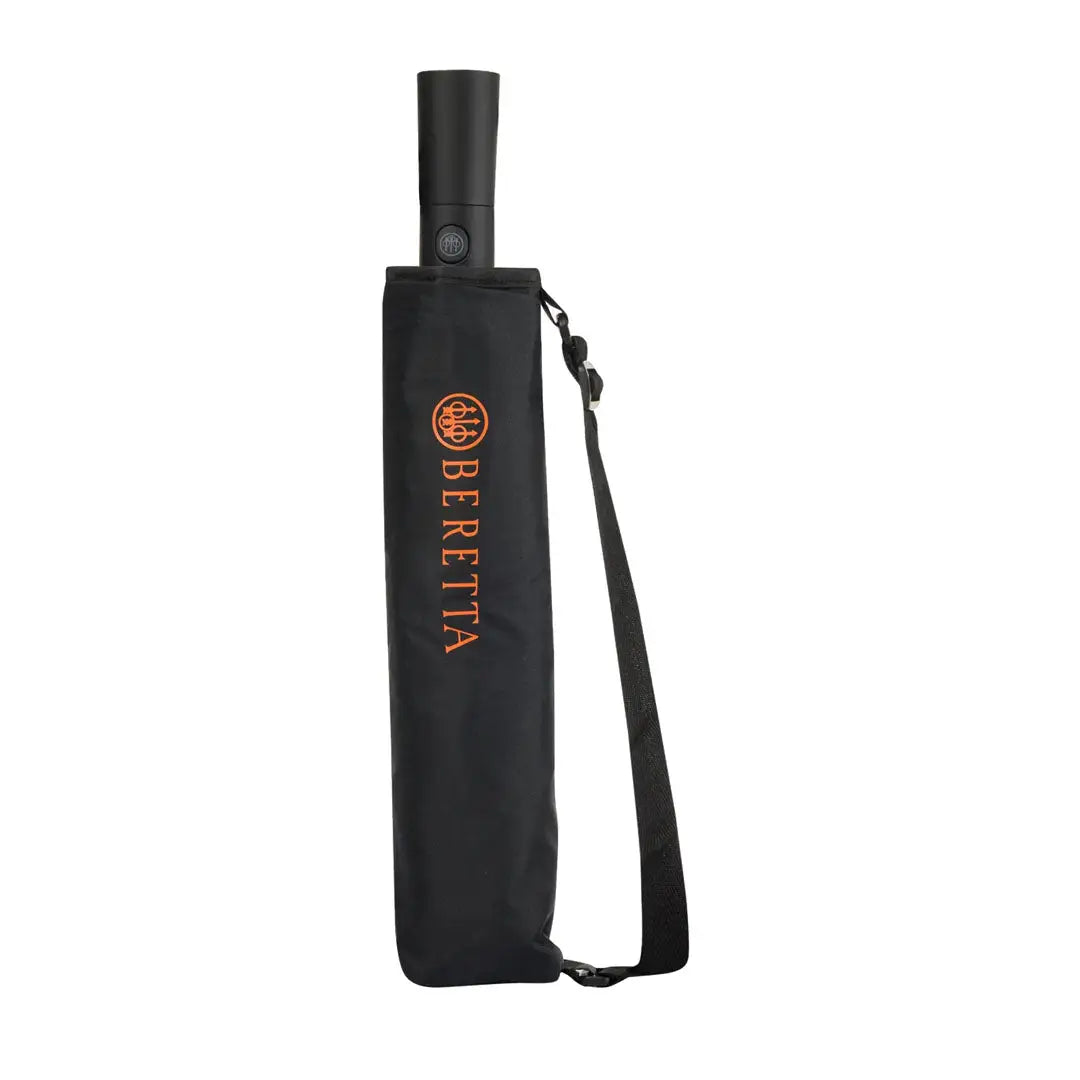 Closed black Beretta foldable umbrella with carrying strap for easy travel