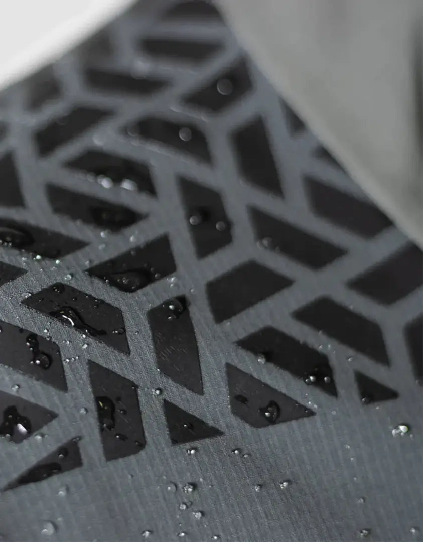 Textured water-spotted surface on Bushbuck Alpine Waterproof Jacket for outdoor adventures