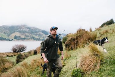Hunter with dogs wearing the Bushbuck Huntsman Bushshirt for outdoor adventures