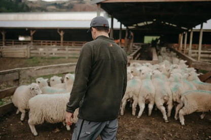 Man overseeing sheep wearing Bushbuck Vertex Fleece Half Zip for outdoor warmth