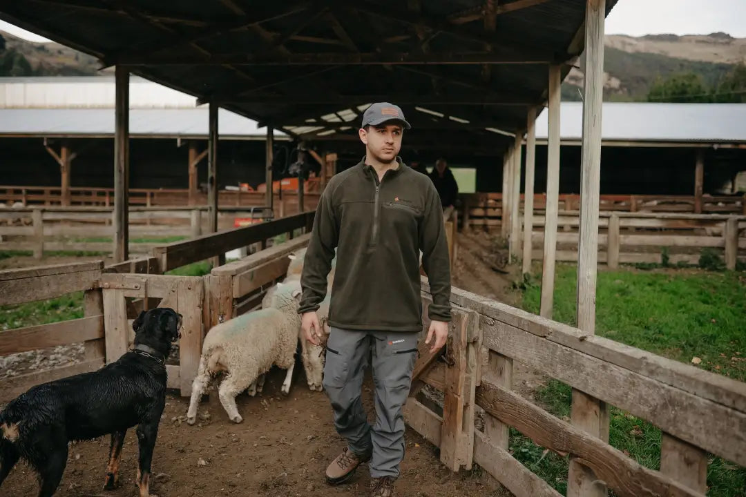 Man in outdoor clothing wearing Bushbuck Vertex Fleece Half Zip for warmth and style