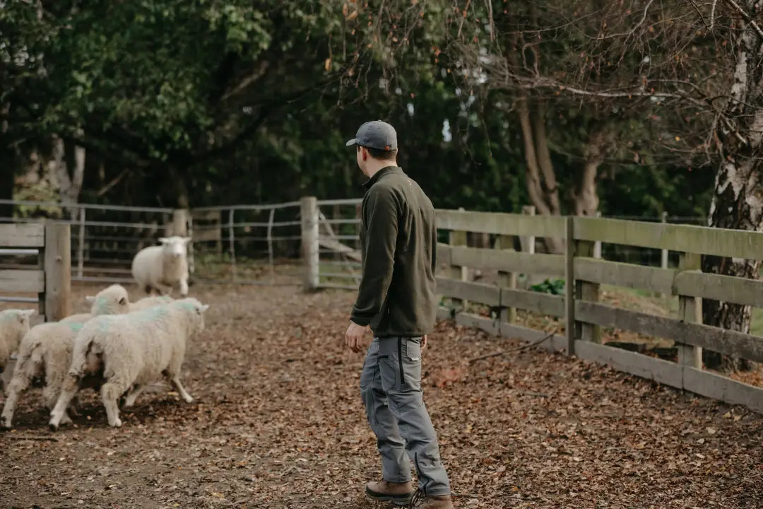 Man herding sheep wearing Bushbuck Vertex Half Zip Fleece for outdoor style and warmth