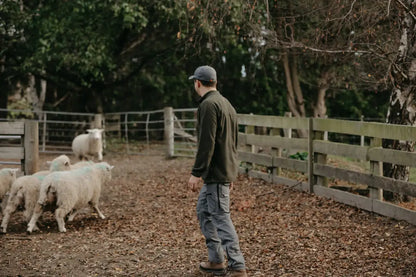 Man herding sheep wearing Bushbuck Vertex Half Zip Fleece for outdoor style and warmth