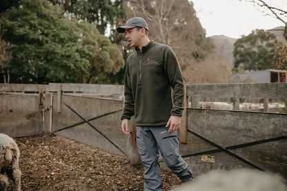 Man in outdoor clothing wearing Bushbuck Vertex Fleece Half Zip for adventure warmth