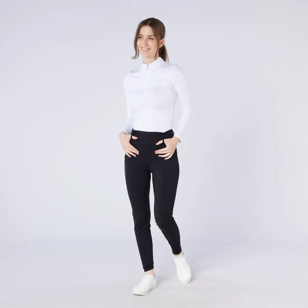 Women’s white long-sleeve quarter-zip top and black slim-fit season tights for country hunting