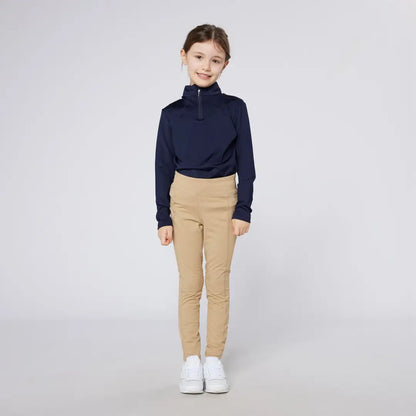 Young girl in navy top and tan pants wearing Cameo Junior Core Tights for comfy style