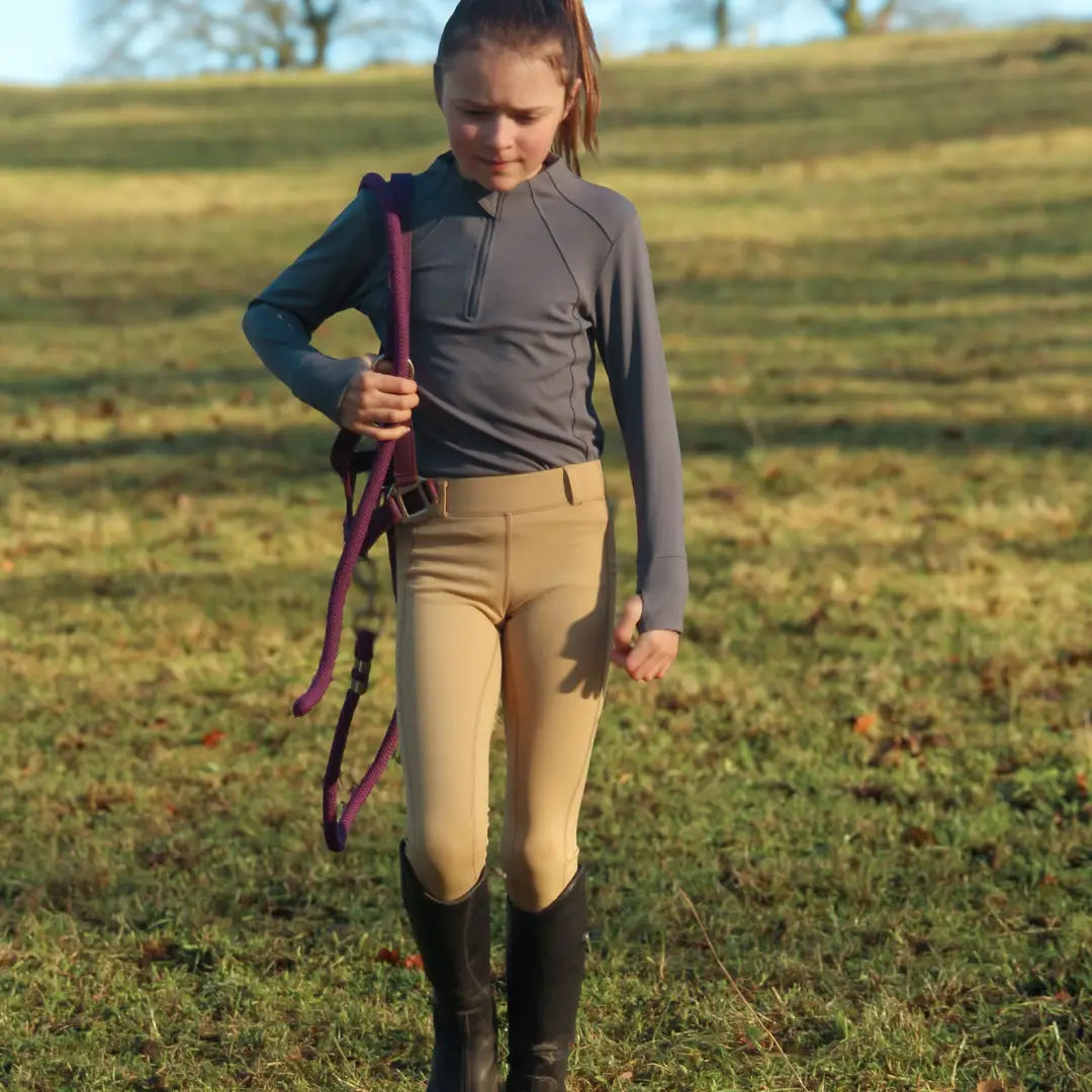 Young girl in riding attire with lead rope wearing Cameo Junior ThermoDry Riding Tight for outdoors or country clothing