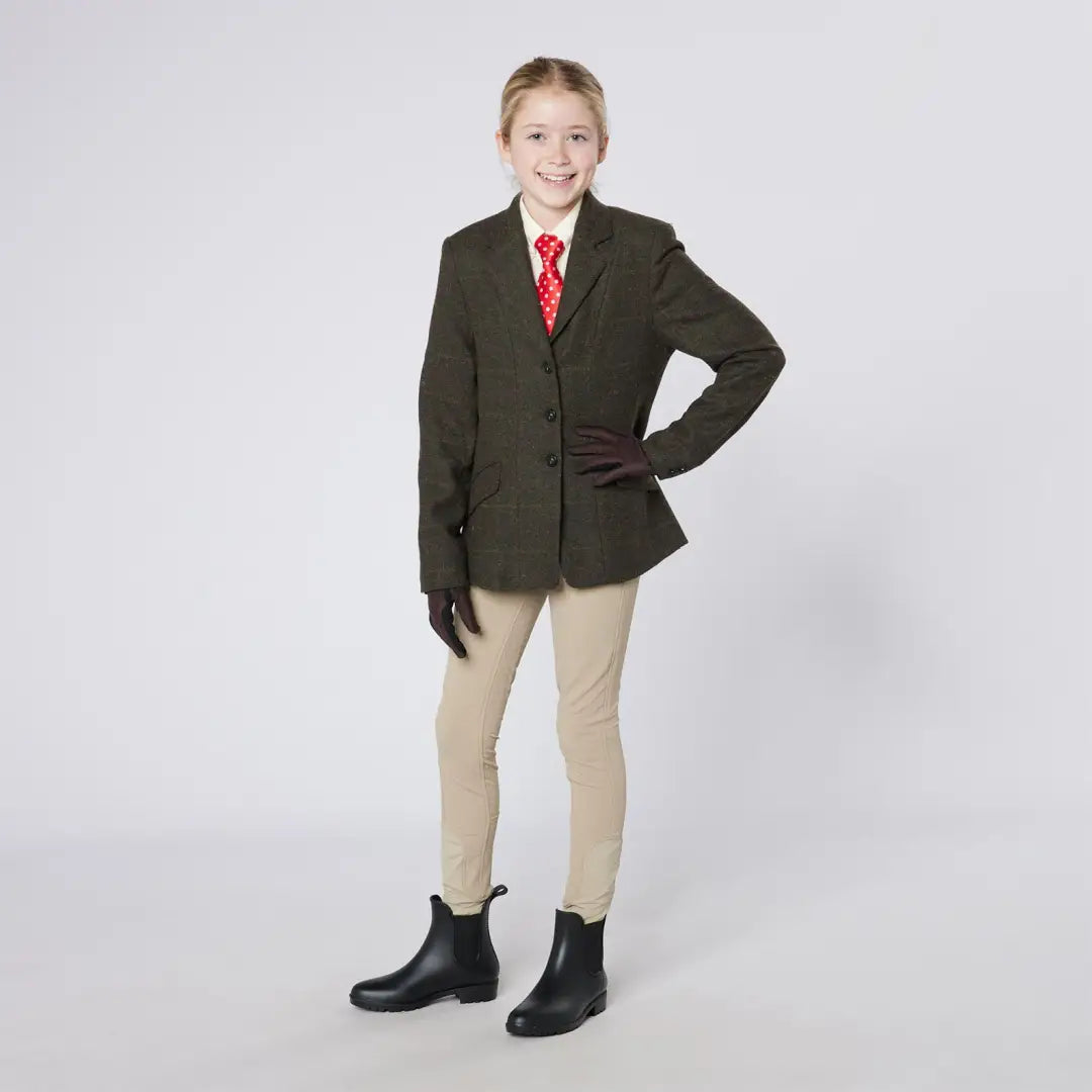 Girl in equestrian attire wearing Cameo Junior Tweed Jacket with foxhead buttons for hunting style