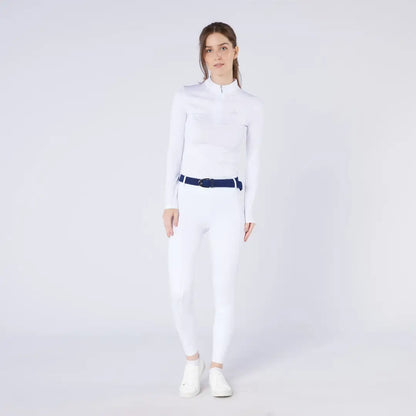 Woman in white athletic wear with navy belt and white shoes, perfect for country clothing outdoors