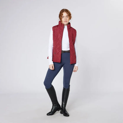Women’s quilted country clothing vest with navy riding breeches and black boots for outdoors