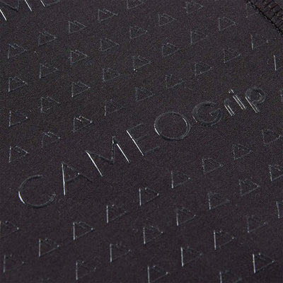 Close-up of black country clothing fabric with triangular pattern and Cameo Grip embossing