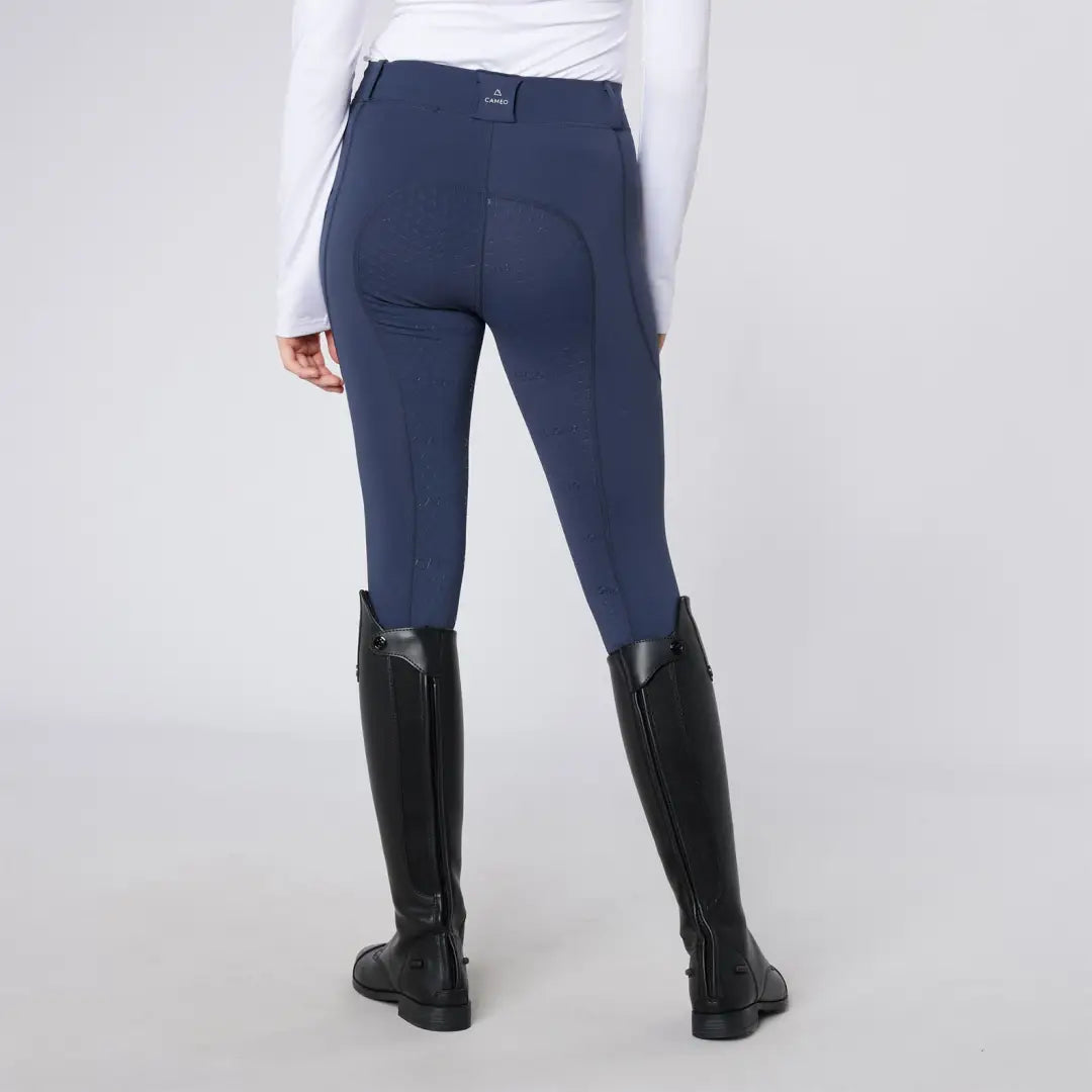 Navy blue women’s equestrian breeches with black riding boots for country clothing outdoors