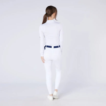 Woman in white long-sleeved shirt and pants with navy belt wearing Cameo ThermoDry Riding Tight for country clothing outdoors hunting
