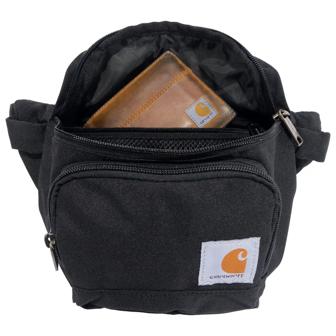 Black Carhartt Classic Waist Pack with brown leather wallet inside