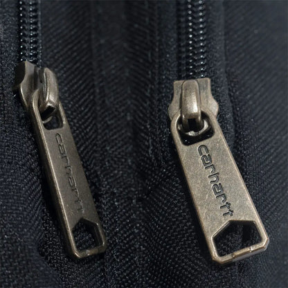 Carhartt zipper pullers on black fabric of crossbody zip bag