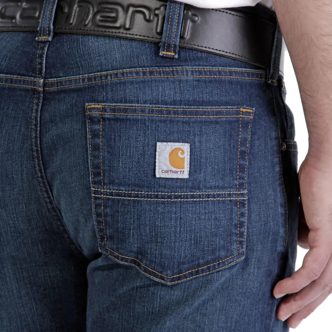 Dark blue Carhartt relaxed straight jeans with classic logo patch on back pocket