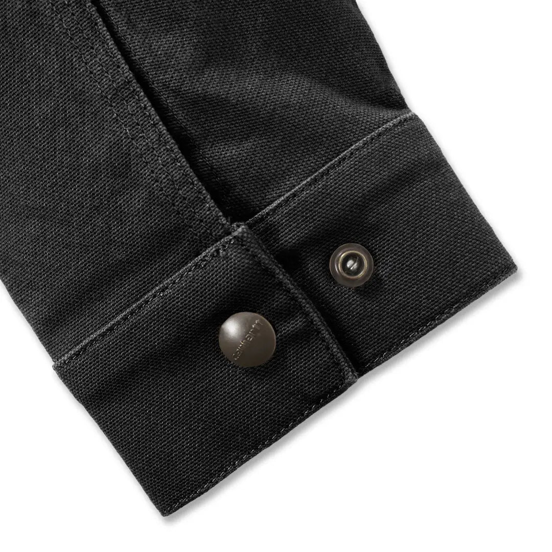 Black denim sleeve with metal buttons on Carhartt Rugged Flex outdoors jacket