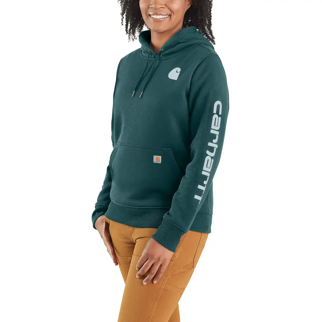Woman wearing a green Carhartt relaxed fit hoodie ideal for country clothing and hunting