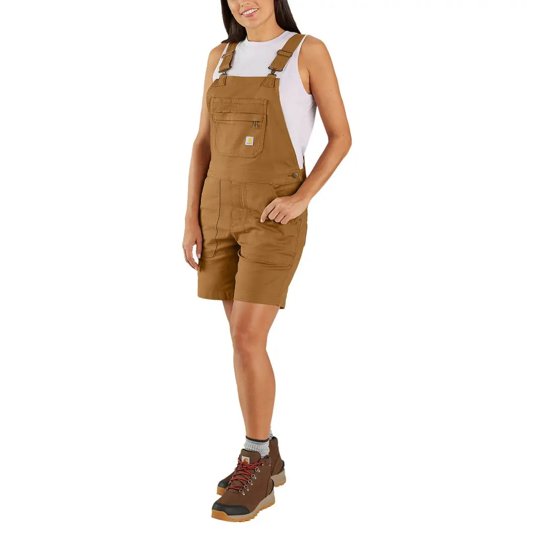 Woman wearing brown Carhartt womens relaxed fit canvas shortalls, great for country clothing and hunting