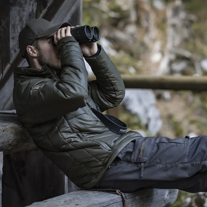Person in Deerhunter Heat Jacket using binoculars in the great outdoors
