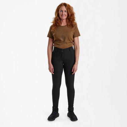 Standing woman in brown t-shirt and black pants wearing Deerhunter Lady Hunting Tights