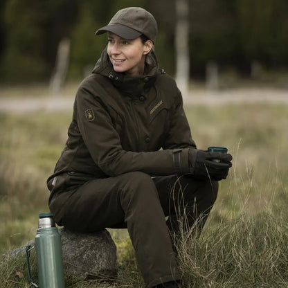 Woman in Deerhunter Lady Mary Jacket sitting on a rock, enjoying a mug